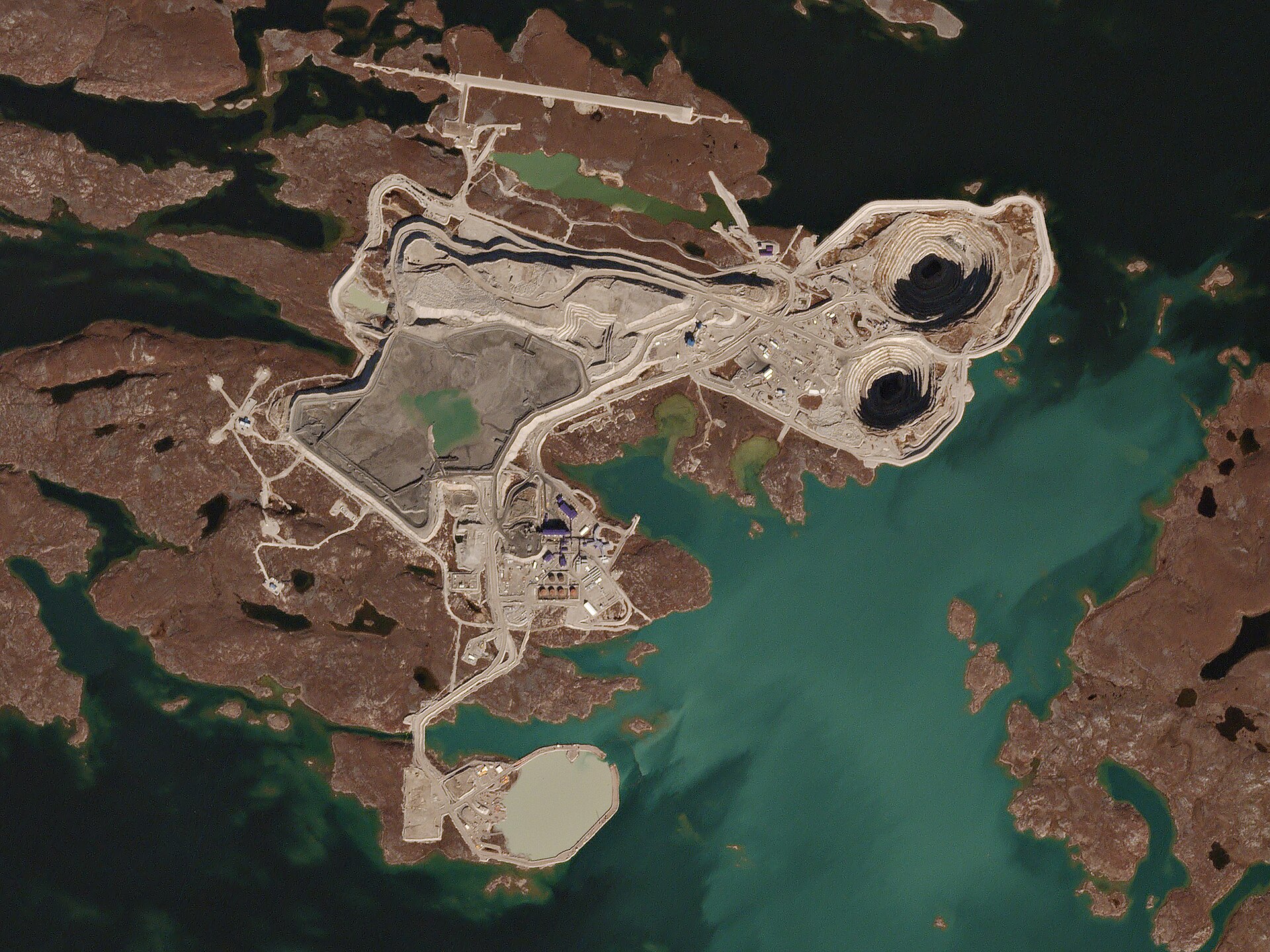 Satellite view of open-pit mine workings on an island in Lac de Gras, surrounded by sub-Arctic tundra
