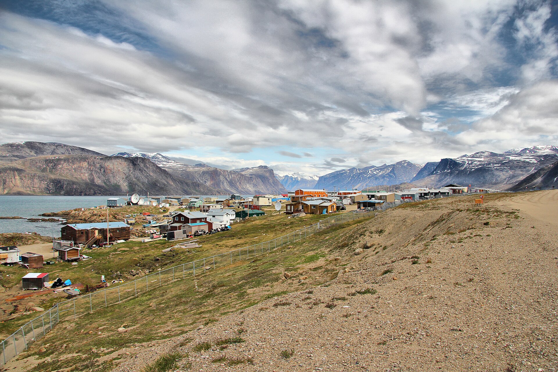 The community of Pangnirtung in winter, beneath steep fjord mountains